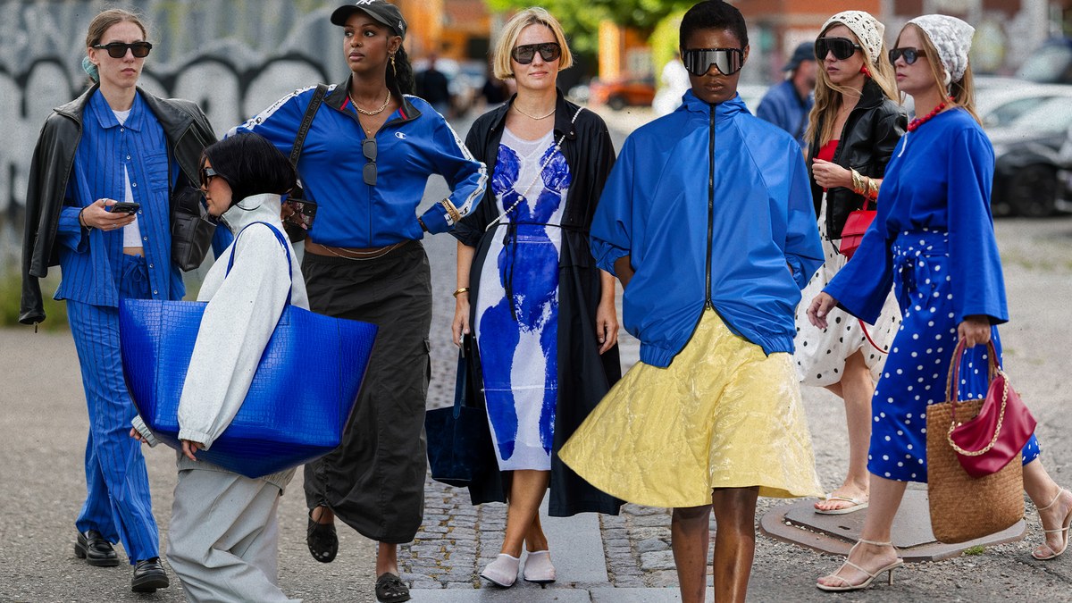 A group of women on the street wearing cobalt blue outfits, from tailored separates to an oversized jacket.