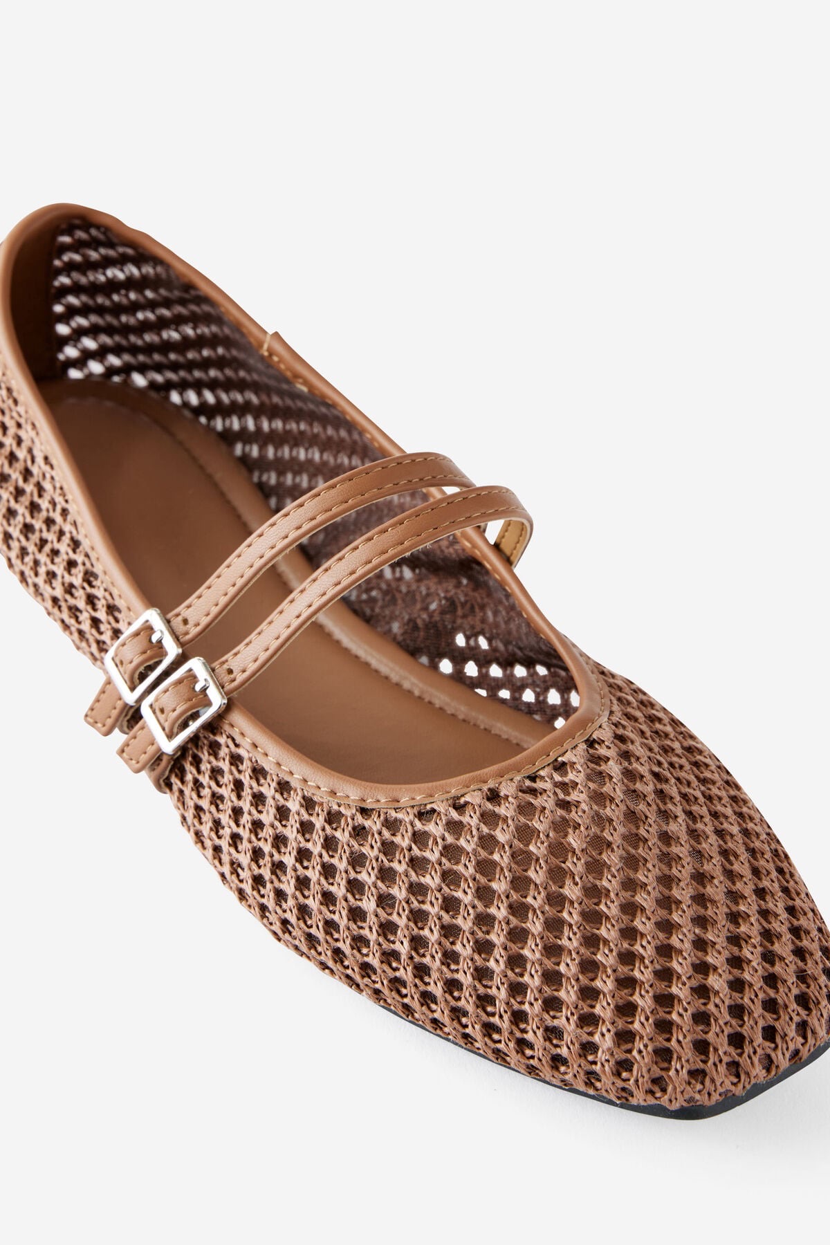 Tan woven mesh ballet flat with a double crossover strap and buckle closure, mary-jane style